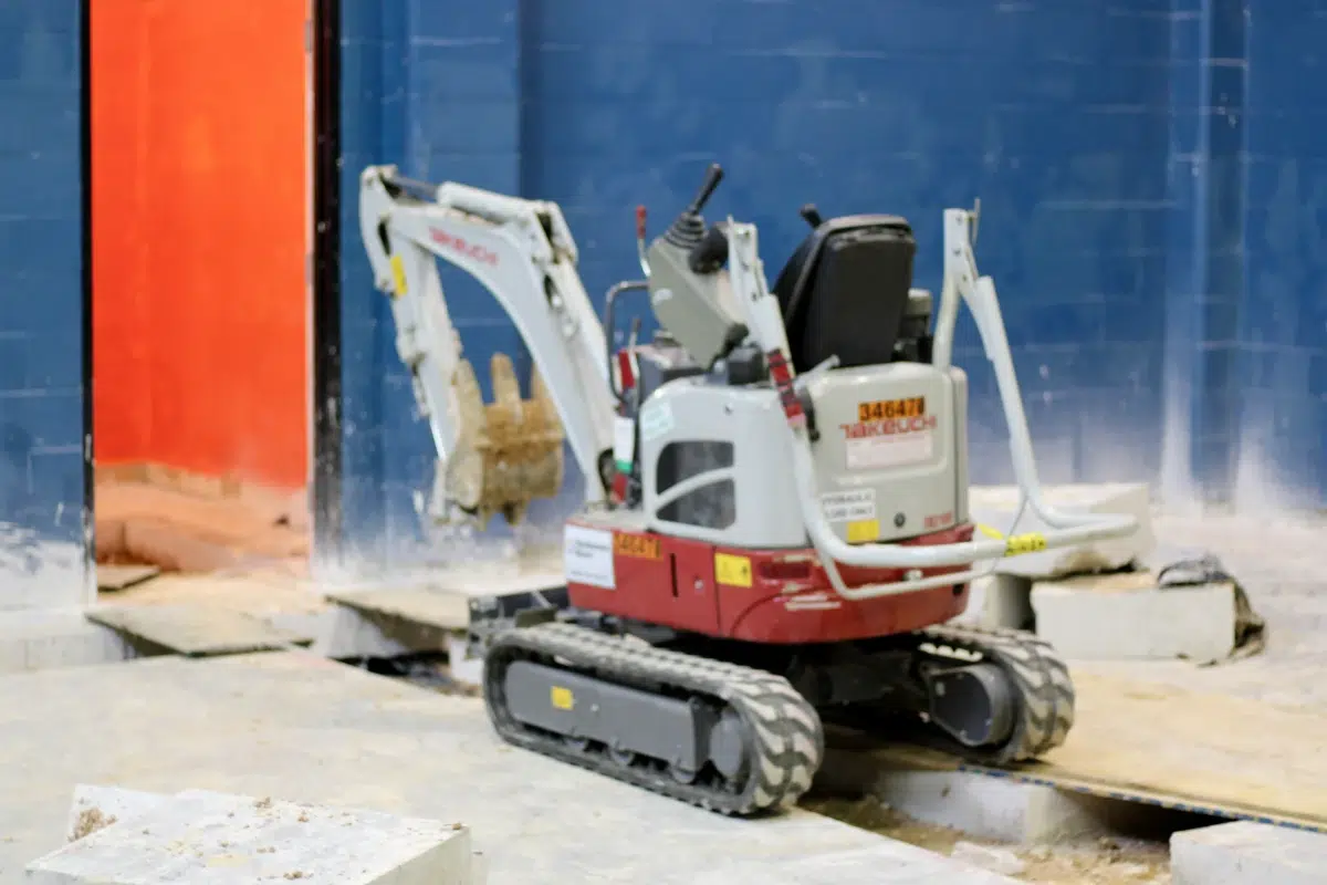 Mini excavator on construction site.