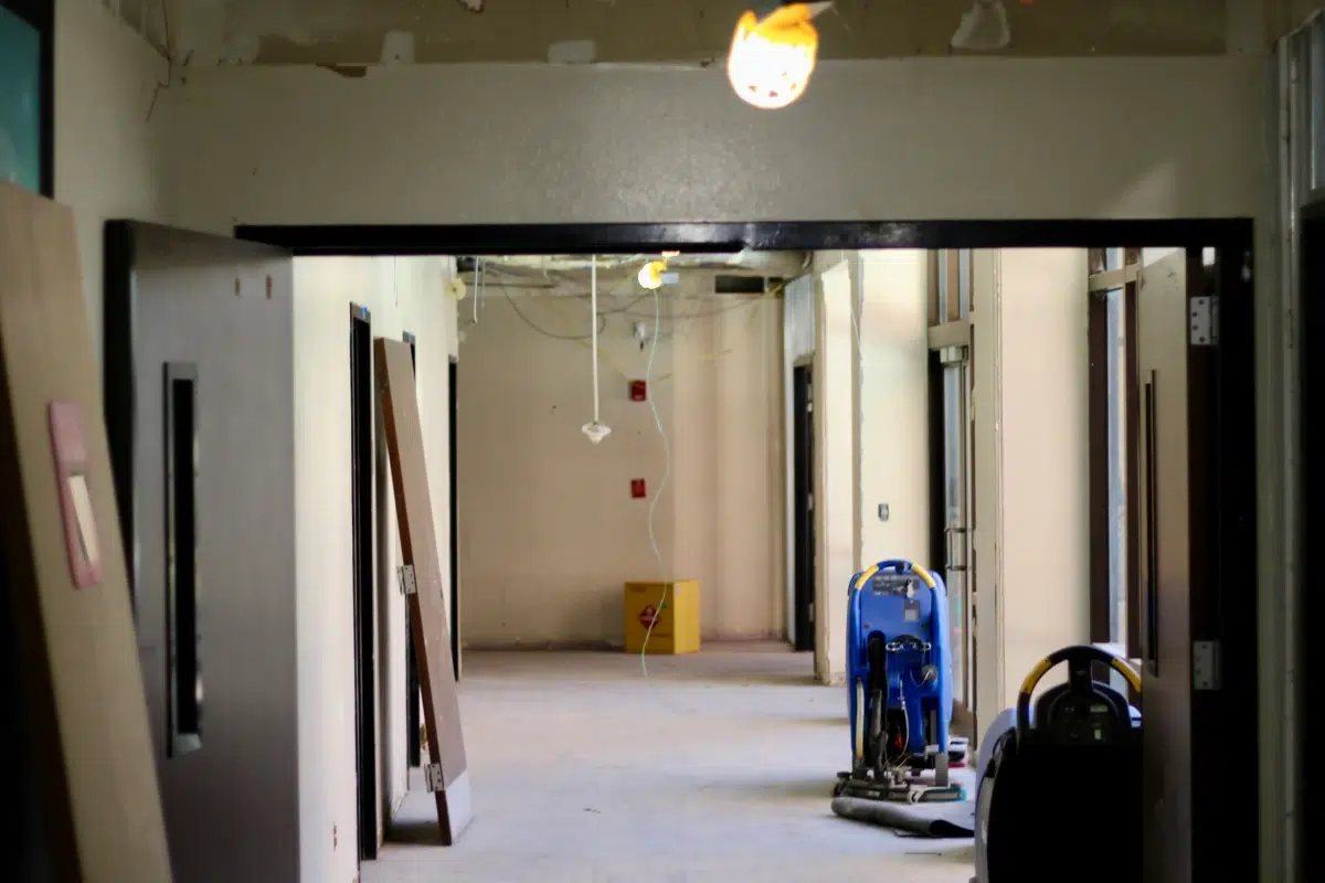 Construction hallway with tools and lighting.